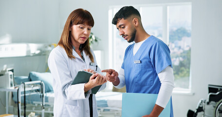 Doctor, nurse and planning with tablet in clinic for training, research and teamwork or management....