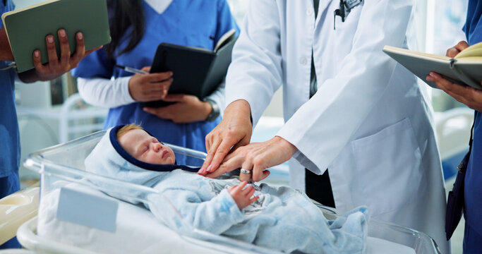 Hands, nurses and doctor with CPR training on baby doll for medical simulation, life saving or notes. People, health interns or expert with mannequin in clinic for infant chest compressions or skills
