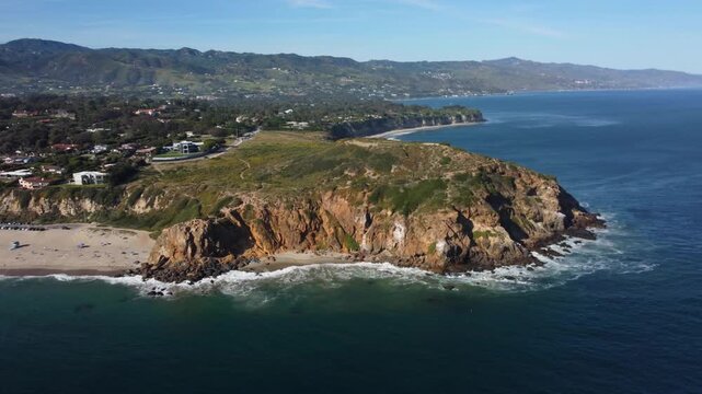 Point Dume, Malibu, Southern California, USA. Pristine Sandy Beach Shoreline in a Tropical Paradise. State Park Beach Area. Coastal cliffs on Pacific Ocean. Drone Shot of blue water and waves.