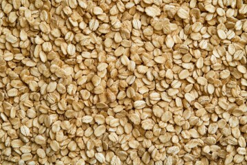 Fototapeta premium Whole grain cereal texture featuring a natural rough surface, showcasing healthy grains in a close-up view for culinary and health-related projects