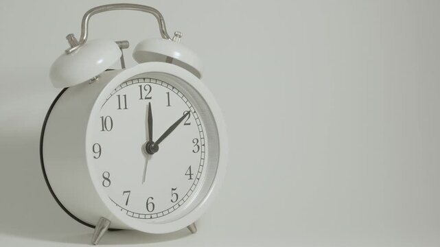 Tme lapse video of a clock time passing over a day to night on white background.