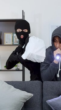 Two Burglars in Ski Masks and Hoodies Robbing a Living Room