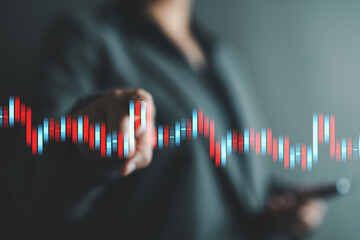 Close-up of businessperson interacting with virtual candlestick trend chart. Business stock trading, financial data analysis and real-time market insights in digital interface.