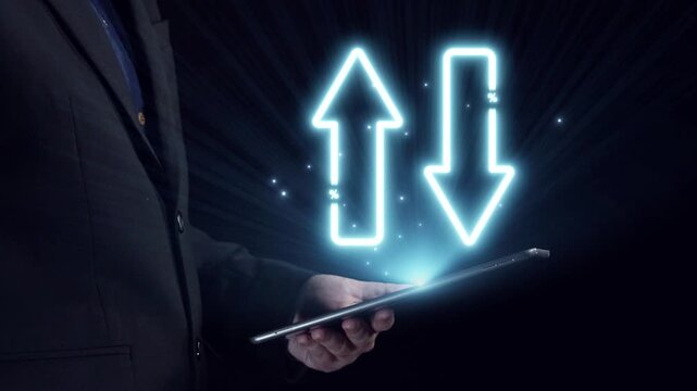 A businessman holds a tablet, showcasing neon arrows representing rising quality and falling cost against a dark backdrop, illustrating financial dynamics and market trends. Qubit