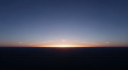 Fototapeta premium Bright horizon line glows between dark earth and deep twilight sky.