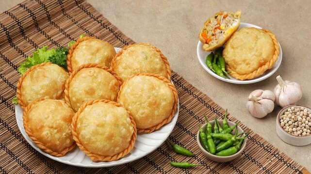 Pastel goreng, curry puff, karipap or empanadas shaped round