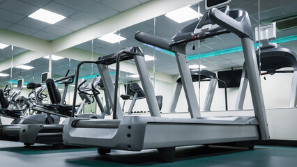 Treadmill with treadmill and exercise machines in gym during daytime. Fitness.