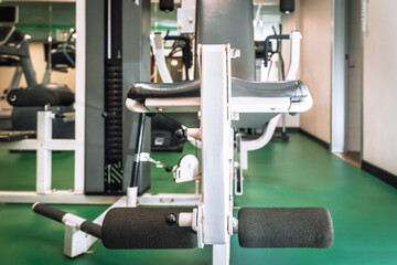 Gym equipment with green floor and workout area. Fitness.