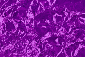 Shiny purple foil texture background, pattern of violet wrapping paper with crumpled and wavy.