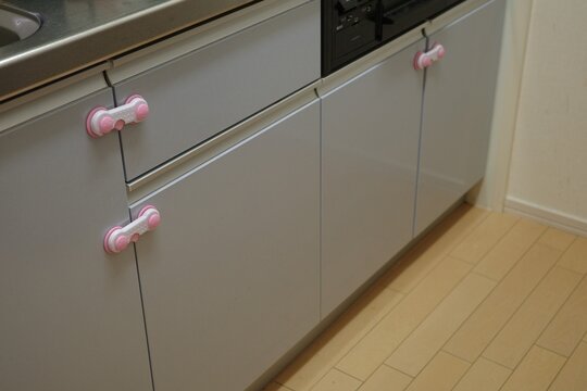 Child proof safety locks installed on kitchen cabinet doors and drawers.
