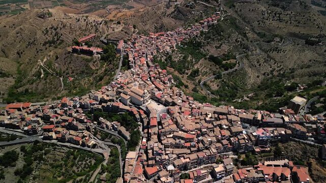 Cinematic drone shot emphasizing the contrast between the quiet hill town and the vast volcanic backdrop.Drone footage revealing Centuripe&rsquo;s elongated hilltop form framed by distant Mount Etna.