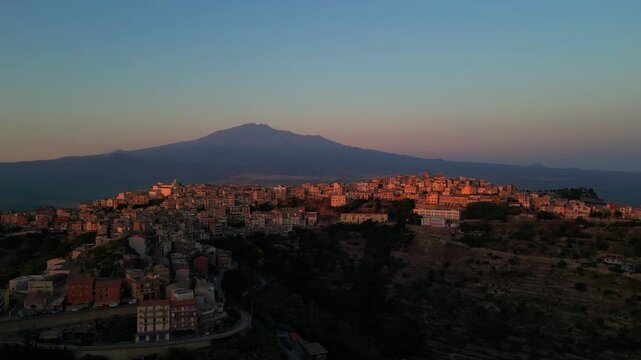 Wide drone shot of Centuripe at golden hour with layered mountains and plains beyond.
Aerial drone panorama capturing Centuripe under soft evening skies.Drone view of Centuripe with sunset tones refl