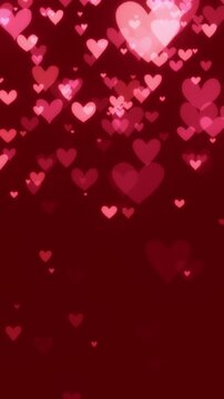 Romantic red and pink heart particles slowly floating downward on red background. Soft glowing hearts celebrating love, affection, passion, or for loving Valentine's day backgrounds.