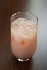 Cold pink guava juice with milk and ice cubes