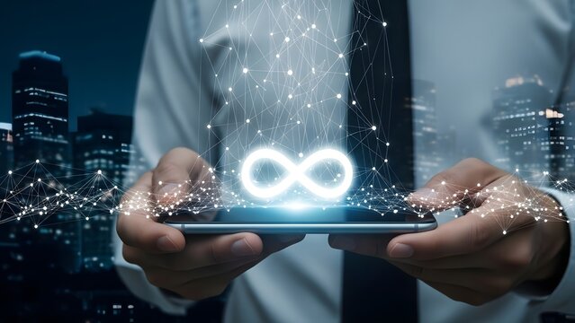 Businessman holding tablet showing digital infinity symbol over futuristic cityscape - Powered by Adobe