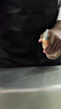 Spray, cleaning and hospitality with hands in kitchen for bacteria prevention, food safety or hygiene. Germ protection, chemical or maintenance with person in restaurant for disinfection and catering