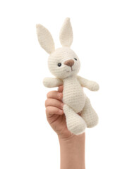 Obraz premium Child's hand with toy bunny on white background