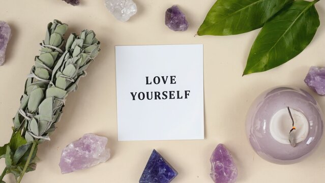 Love yourself card with sage amethyst and candle on beige surface