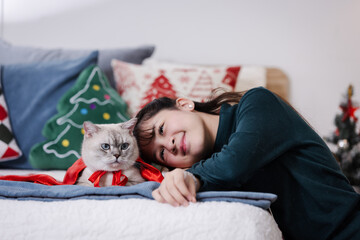 Cozy Christmas Moment Woman Relaxing with Cat at Home