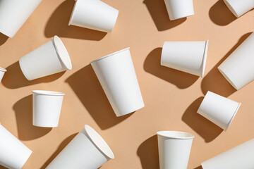 Composition with different paper cups on beige background