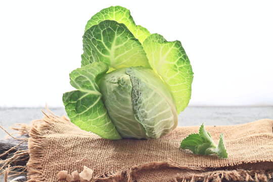 Fresh Green Cabbage Head on Burlap Cloth