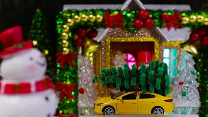A yellow car pulls up to a Christmas house with a decorated arch and a snowman in the foreground