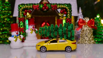 A yellow car pulls up to a Christmas house surrounded by bells and Christmas trees with snowmen on the porch and a decorated arch