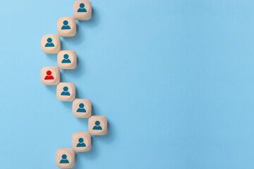 Business concept image of wooden blocks with people icons over blue background, human resources and management concept
