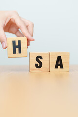 Naklejka premium hand change wooden block from FSA. HSA, Flexible Spending Account and Health Savings Account, Medical Expenses, Tax Benefits and healthcare concepts