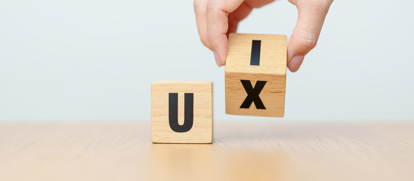 hand change wooden block from UI to UX. User Interface and User Experience, Usability, Information Architecture, IA, Research, Prototype, Testing, Onboarding, Design Thinking and Wireframe concepts
