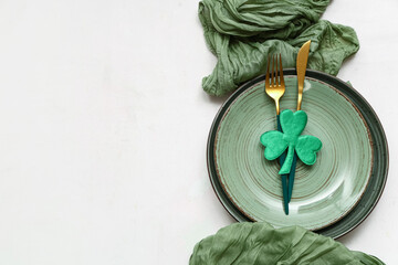 Table setting for St. Patrick's Day celebration on white background