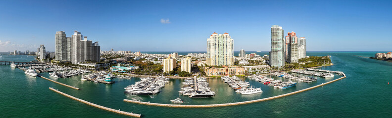 Panorama of Miami skyline and Biscayne Bay. Panoramic cityscape with coastal skyscrapers. Scenic view of Miami Beach from above. Drone captures Fisher Island and waterfront.