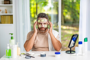 Facial mask of cucumber. Cosmetic beauty man with cucumber slices on face. Hispanic man with facial mask. Man fill skin with vitamin. Man applying facial mask with cucumber. Moisturizing effect