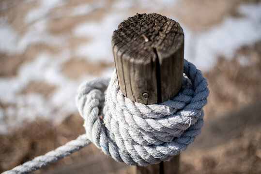 Weathered Wooden Post with Rope Knot