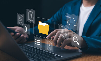 Digital transformation and data management concept.Businessman use laptop to interface with cloud computing and document organization systems, ensuring secure file storage, for modern business.