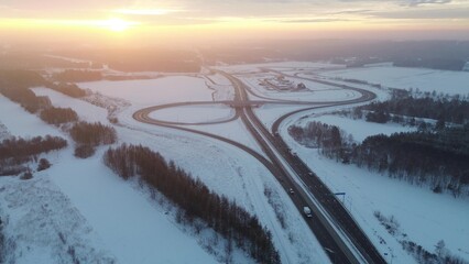 Winter road illuminated by sunset glow