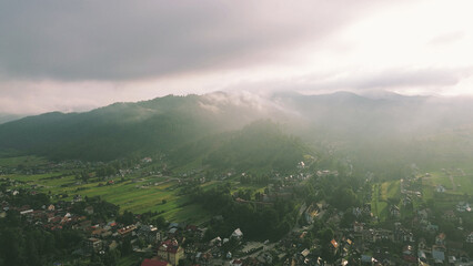 Fototapeta premium Serene rural valley with fog and sunrise glow