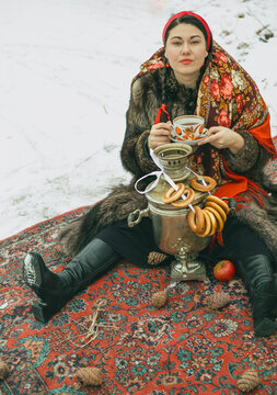 A Russian woman wearing a kokoshnik drinks tea from a samovar