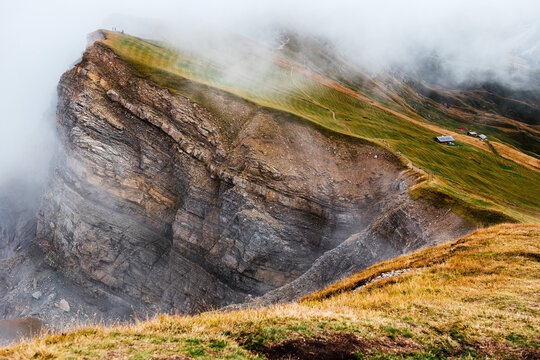 Seceda mountain ridge with rock formations and misty alpine landscape
