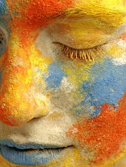 Eyes closed face surrounded by flowing colors, creative mind visualization, soft lighting, copy space