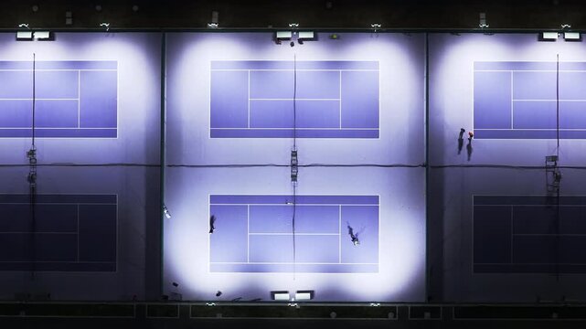 Aerial view of modern tennis court at night