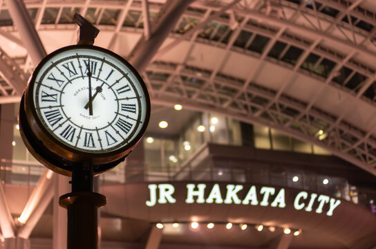 Illuminated station clock at JR Hakata City at night, Fukuoka, Japan.