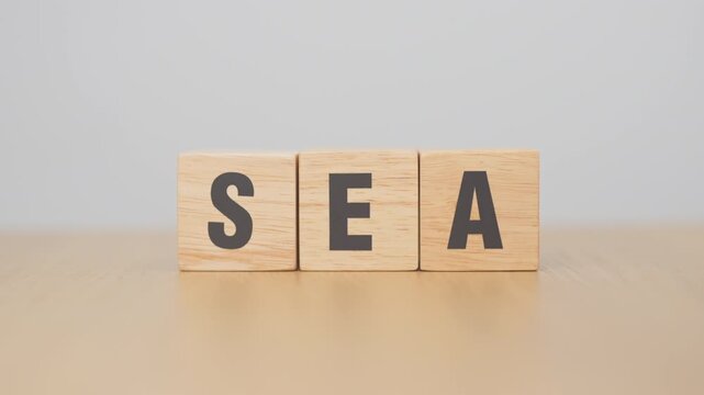 Hand change Wooden block from SEA to SEO. Search Engine Optimization, SEM, Advertising, Marketing, Idea, Strategy, Keyword, Content and technology concept