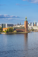 Obraz premium Stockholm, Sweden skyline by the water with historic towers and green hills