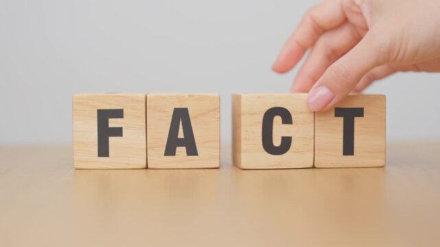 hand change wooden block FAKE to FACT. rumor News, false, myth, evidence and disinformation concepts