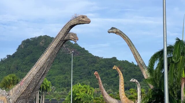 Thailand, July 11, 2025: Dinosaur Valley in the Nong Nooch Tropical Garden in Pattaya. Dozens of life-size dinosaur sculptures. Each figure is accompanied by a description plate: era, habitat. 4К
