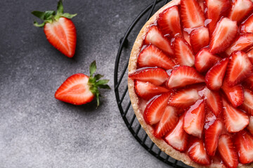 Stand with sweet strawberry tart on grunge background, closeup © Pixel-Shot