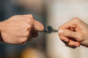 two hands pulling on the house key