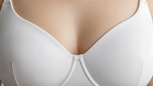 closeup female breast in white bra lingerie underwear fashion comfort style body shape cleavage skin care beauty wellness texture detail fabric material model