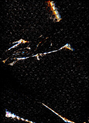 High contrast bubble wrap texture on black background with glowing light reflections. Abstract plastic pattern, futuristic industrial surface, dramatic lighting, creative packaging concept.